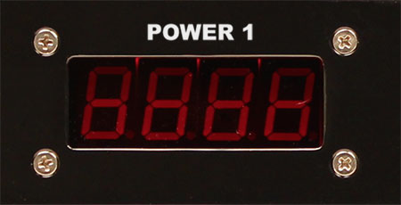 A photo of a digital LED display used to show the voltage of a powe line.